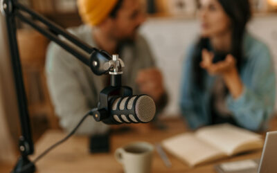Professional microphone recording podcast interview with speakers Studio microphone capturing audio for a podcast with blurred hosts talking